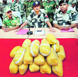 BSF officials display the 22-kg heroin worth Rs 110 crore seized in Ferozepur on Monday