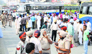 Private bus operators block traffic in Moga on Monday.