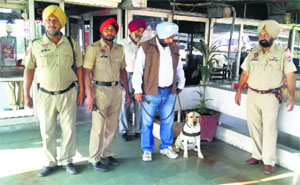 Policemen with a sniffer dog at the Floating Restaurant in Fatehgarh Sahib on Monday
