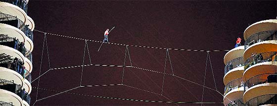  Residents watch from their balconies as tightrope walker Nik Wallenda walks blindfolded along a wire between the towers of the Marina City condominium buildings in Chicago, Illinois, on Sunday. The Marina City towers are 588-feet tall. 