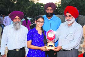 Winner of the inter-departmental basketball championship receives the trophy on GNDU campus in Amritsar on Tuesday