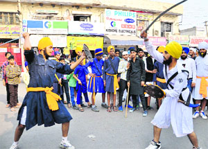 Members of the Baba Deep Singh Gatka Party display their martial skills during a procession to mark the birth anniversary of Guru Nanak Dev in Bathinda on Tuesday