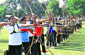 Participants in action during the PU inter-college archery competition in Chandigarh on Tuesday.