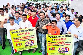 Computer shopkeepers protest at Sector 20 in Chandigarh on Tuesday. 