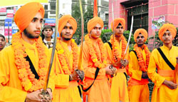 Youths dressed as Panj Pyaras during a Nagar Kirtan procession in Dehradun on Tuesday. Tribune photo: Abhyudaya Kotnala