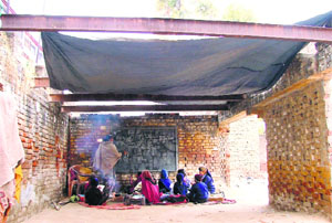 Students of Government Primary School, Jail Road, Ludhiana, sit on the floor with a tarpaulin for a roof. State of rural schools is worse