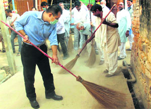 DC Shekhar Vidyathi participates in a cleanliness campaign at Manesar village in Gurgaon on Tuesday