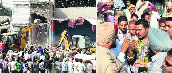 MC teams with the help of JCB machines pull down front portion of shops; (and right) shopkeepers argue with the police on Pathankot Road in Jalandhar on Tuesday.