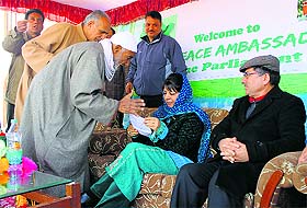 PDP president Mehbooba Mufti gives a patient hearing to an elderly man.   