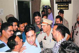 BJP leaders argue with traffic in-charge Baldev Raj outside the office of the Deputy Commissioner of Police in Amritsar on Wednesday