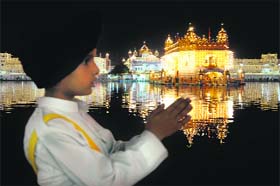 Reverence for almighty: A child pays obeisance at the Golden Temple on the eve of the birth anniversary of Guru Nanak Dev in Amritsar on Wednesday