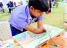 A youth paints a picture at the event