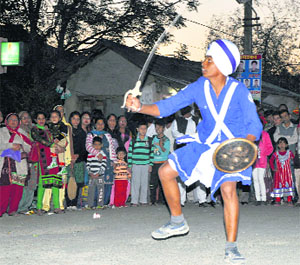 A Sikh youth performs gatka during a nagar kirtan on the eve of birth anniversary of Guru Nanak Dev ji in Dharamsala on Wednesday.