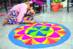 A girl makes a rangoli