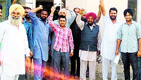 Farmers protest outside a power station in Moga on Wednesday.