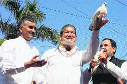 Chief Minister Harish Rawat releases a pigeon at the Baikunth Chaturdashi Mela at Srinagar in Pauri Garhwal district on Wednesday. a tribune photograph