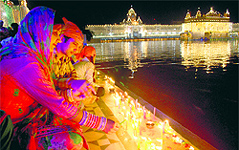 Devotees light candles at the Golden Temple on the occasion of Guru Nanak Devs birth anniversary