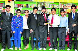 The IIMUN team at One Up with their winning trophy