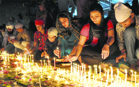 Devotees light up candles in the evening