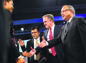 James Hogan (2nd R), CEO of Etihad Airways, shakes hands with delegates during the India Economic Summit 2014 in New Delhi on Thursday. He welcomed the approach of the Modi government.