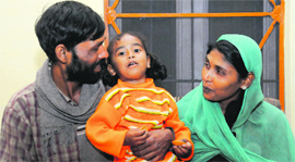Rahul with his parents after being rescued by the Mohali police.