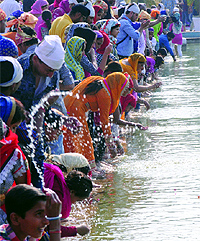 Devotees at the holy sarover to mark the 545th birthday of Guru Nanak Dev at Bangla Sahib Gurdwara in New Delhi on Thursday