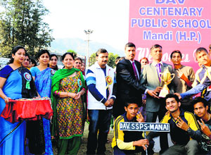 The team of the DAVSSPS in Manali receive the overall trophy of the state-level athletics meet of DAV schools in Mandi on Thursday.