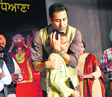 Punjabi actor Binnu Dhillon hugs the child named Bohemia during the youth festival at the PAU.