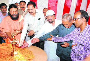 Maha Mandaleshwar SwamI Hari Chetnanand Maharaj along with SP, City, KL Shah lights a traditional lamp at Shyampur in Haridwar on Thursday. 