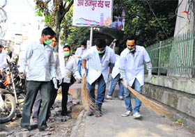 Protesting members of the Unemployed Diploma Pharmacists take to brooms to contibute to the Swachh Bharat Abhiyan in Dehradun on Thursday. 