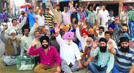 Residents living in the localities around the Bhagtanwala dumping yard protest in Amritsar on Friday.