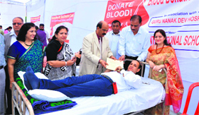A resident donates blood at a camp organised at DAV International School in Amritsar on Friday.