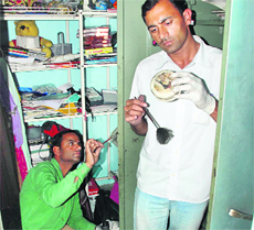 Forensic experts collect finger prints from a house after robbery in Sector-15, Panchkula, on Friday.
