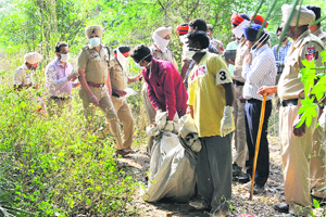 The police with the victim's body that was found buried in Sector 69, Mohali, on Friday.