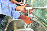 Students wash their hands without soap at a government school in Chandigarh on Friday.