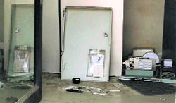 Parts of the broken SBI ATM in Jind on Friday. Tribune photo