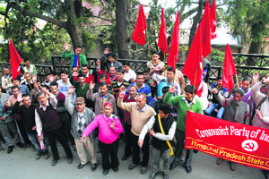 Victims of the monkey menace, who got together under the banner of CPM, raise slogans in front of the DC office in Shimla on Friday.