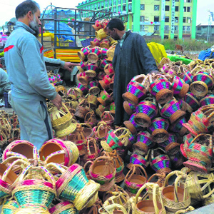 A vendor sells kangris (earthen fire pot) in Srinagar on Friday.