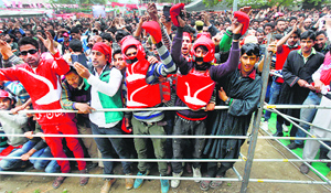National Conference supporters wearing the party election symbol.
