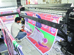 Posters being printed for the coming Assembly elections in Jammu on Friday.