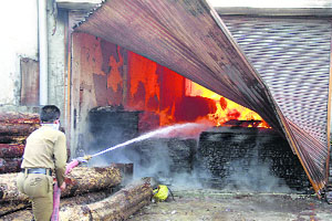 Firefighters douse flames at the timber store near Octroi Post on Ferozepur Road in Ludhiana on Friday