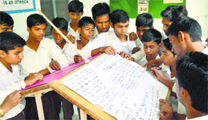 Students sign the Winter on Wheels campaign at Government High School, Sarabha Nagar, in Ludhiana