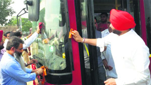 MP Ravneet Singh Bittu and MLA Bharat Bhushan Ashu clean a bus in Ludhiana on Friday