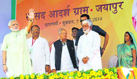 Prime Minister Narendra Modi waves to the crowd at Jayapur village in Varanasi on Friday.