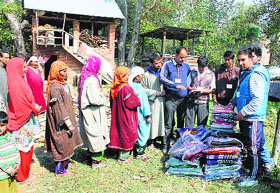 A file photo of volunteers distributing relief material among flood-hit people in Pulwama district of Kashmir