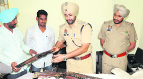 The Amritsar police with weapons recovered from local resident Simarjit Singh on Friday.