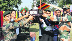 The 23 Infantry Division with the winning trophy at the conlcusion of the South Western Command Adventure Challenge Cup at Raiwala in Haridwar on Friday. Tribune photo