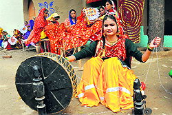 A girl spins charkha during the Virasat Mela at Jaiplagarh Village in Bathinda on Saturday