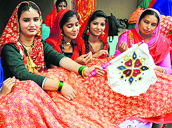 Girls in traditional attire strike a pose