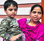 Mehrams friend Sirjan in his mothers lap. His mother refuses to send him to the park